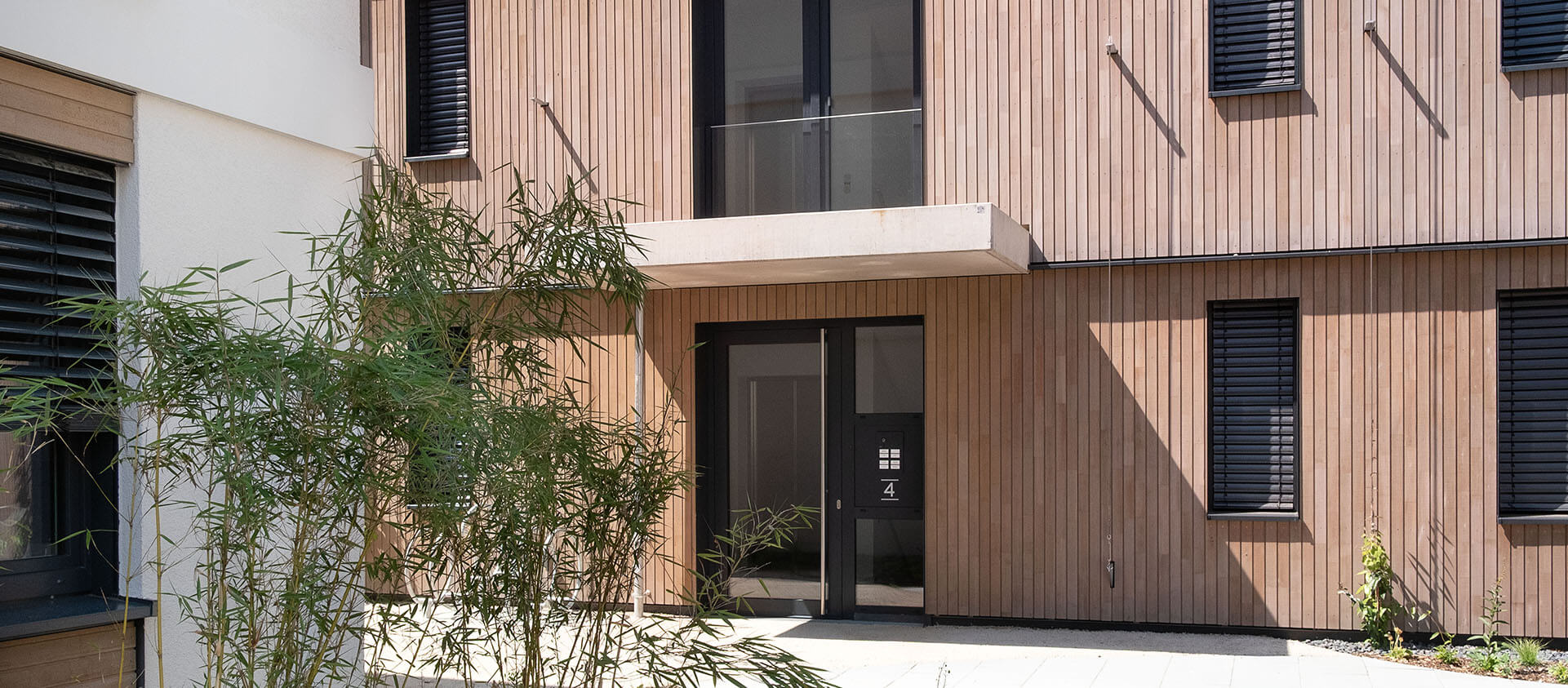 Eingansbereich Neubau Königsteiner Höfe, Gebäude mit Holzfassade